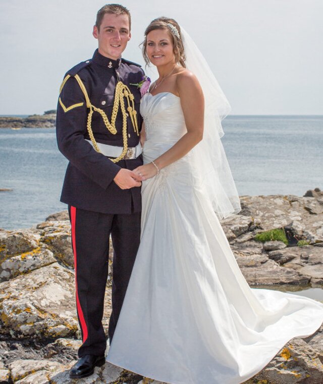 Aimee Maiden and Nick Wheeler at Mousehole beach, Cornwall. A couple browsing old family photo albums ahead of their wedding were shocked to find a picture of themselves playing together on a beach - as CHILDREN. See SWNS Story SWPHOTO. Teacher Aimee Maiden, 25, and her soldier husband Nick Wheeler, 26, had no idea their paths had crossed until they saw the grainy snap taken 20 years earlier. Aimee grew up in the tiny seaside village of Mousehole, Cornwall, and was a regular visitor to the beach - while Nick lived in KENT but just happened to be on holiday there. The two kids, Aimee aged five and Nick aged six, spent the day building sand castles just a few yards apart but their two families never met or spoke. Nick moved to Cornwall a year later but didn't meet 'soulmate' Aimee again till they went to the same sixth form college and fell in love. But they knew nothing about their chance childhood meeting until they began going through old family photos at Nick's grandparents' house ahead of their engagement party last year. They came across the shot of Nick playing on the beach with his sister and cousins when shocked Aimee suddenly recognised herself in the background. 31 July 2014